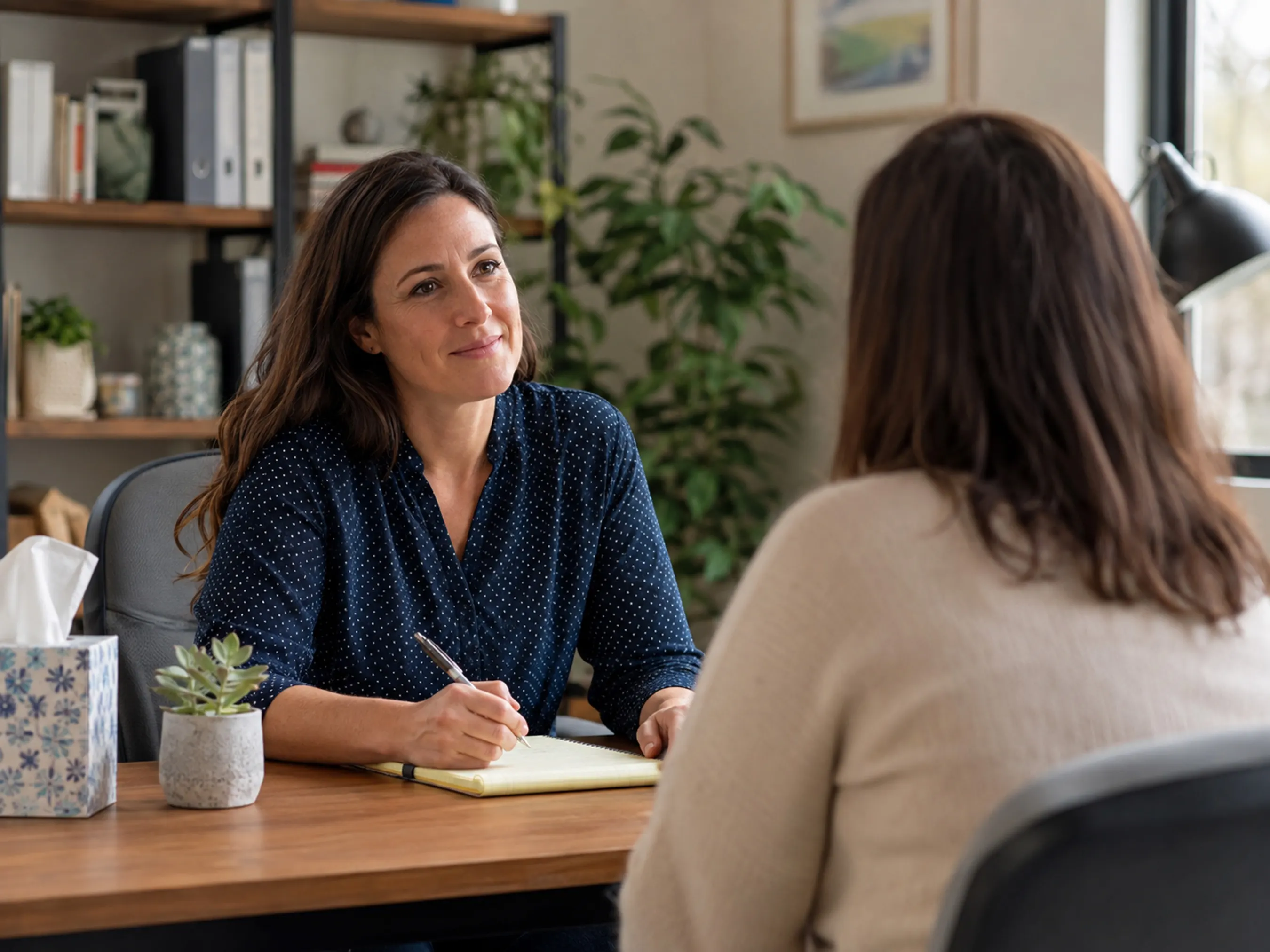 Social worker meeting with a client in a private office